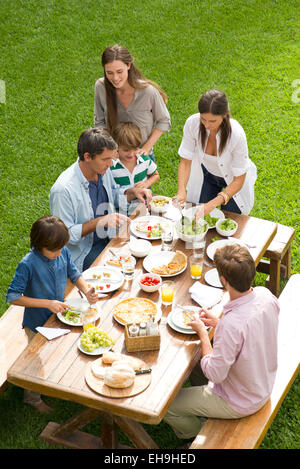 Family and friends enjoy healthy meal outdoors Stock Photo