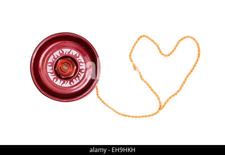 Red yoyo with heart-shaped twine on the white background. Stock Photo