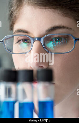 Scientist looking at test tubes in lab, close-up Stock Photo