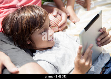 Boy using digital tablet outdoors Stock Photo