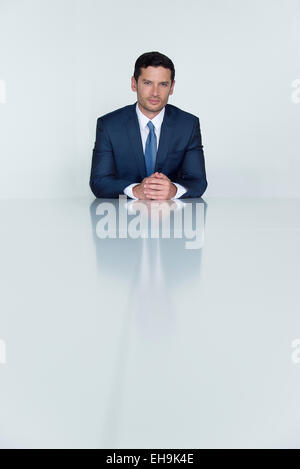 Businessman seated at table, portrait Stock Photo