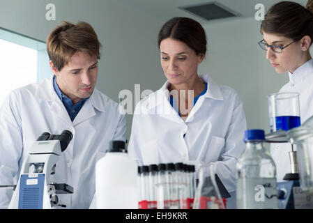 Scientists conducting experiment in laboratory Stock Photo