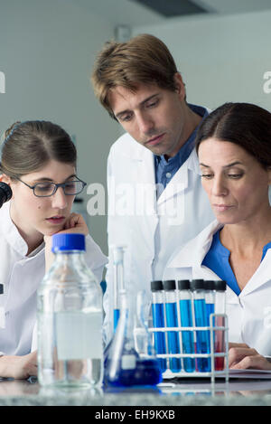 Scientists conducting experiment in laboratory Stock Photo