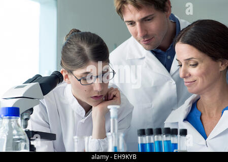Scientists conducting experiment in laboratory Stock Photo