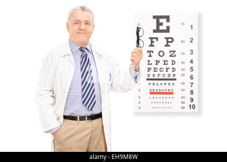 Optometrist holding glasses in front of eye chart isolated on white background Stock Photo