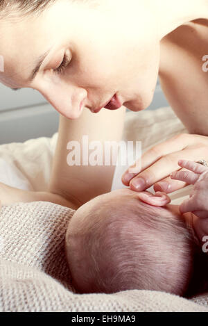 Mother comforting newborn baby Stock Photo