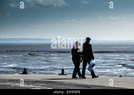 A couple walking on Bell Wharf at Leigh on Sea in Essex. Stock Photo