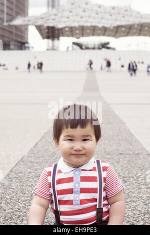 Baby boy in city square, portrait Stock Photo