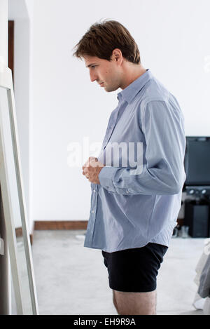 Man getting dressed Stock Photo