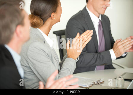 Executives clapping in meeting Stock Photo