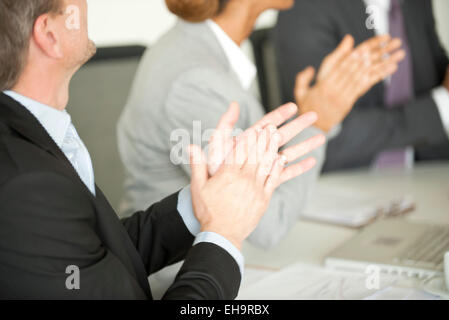 Executives clapping in meeting Stock Photo
