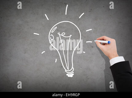 close up of businessman drawing light bulb Stock Photo