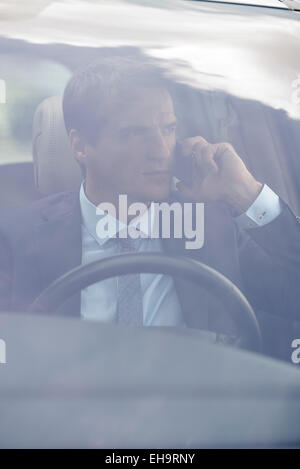Man talking on cell phone while driving Stock Photo