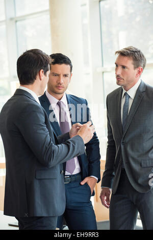 Businessmen engaged in serious discussion Stock Photo