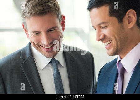 Businessmen talking and laughing together Stock Photo