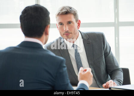 Businessmen in serious meeting Stock Photo