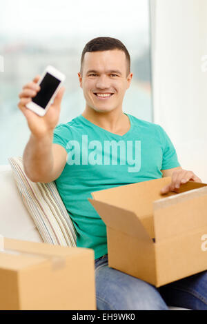 opening cardboard box and taking out smartphone Stock Photo