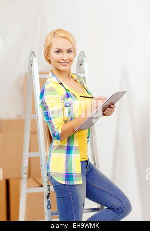smiling woman with clipboard Stock Photo