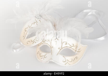 Venetian carnival masquerade mask in white and gold Stock Photo