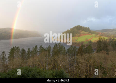 Stunning elevated view of a rainbow forming over Lake Vyrnwy, with the ...