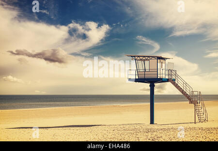 Vintage retro style filtered picture of a lifeguard tower on a beach. Stock Photo