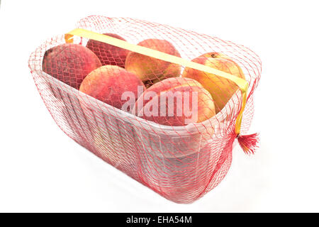 Fresh peaches in plastic bowl isolated on white Stock Photo