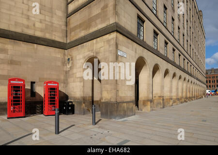 Manchester England: Two Red Telephone Boxes stand outside Manchester Town Hall Stock Photo