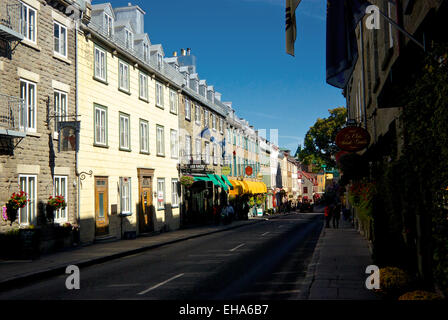 Early morning tourists walking shops and restaurants along Rue Saint-Louis in upper old Quebec City Stock Photo