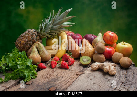 Set of different fresh fruits on a green background Stock Photo