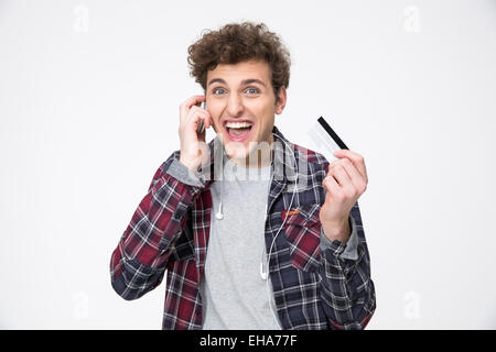 Young man holding credit card and talking on the phone Stock Photo