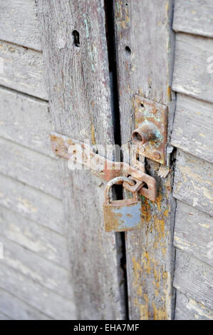 Old and rusty lock on a wooden door Stock Photo