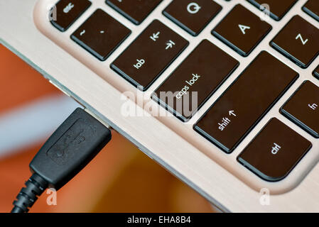 Macbook connected USB cable Stock Photo