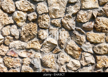 Fragment of a grey stone wall as background Stock Photo