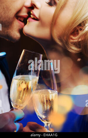 Cheerful couple kissing and drinking a champagne Stock Photo