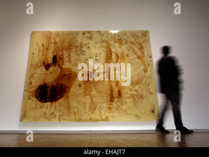 Cologne, Germany. 09th Mar, 2015. A visitor stands in front of paintings of the series 'Die Geister, die Kräfte verleihen sind unsichtbar V' (lit. 'The spirits that lend powers are invisible V') by Sigmar Polke in Cologne, Germany, 09 March 2015. The exhibition 'Alibis' by Sigmar Polke runs from 14 March until 05 July 2015 in the Museum Ludwig in Cologne, Germany. PHOTO: OLIVER BERG/dpa/Alamy Live News Stock Photo