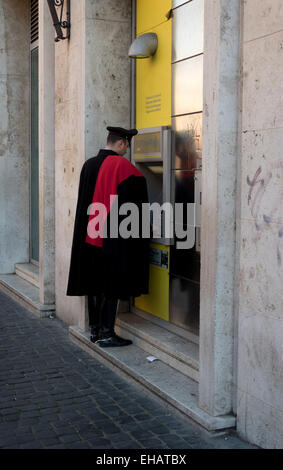 Carabiniere, Italian policeman withdrawing money, cash from ATM machine in bank. Rome, Roma, Italy, Italia, Vatican city Stock Photo
