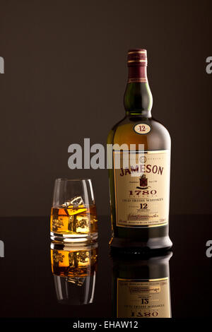 Jameson Whiskey bottle and glass with ice cubes Stock Photo