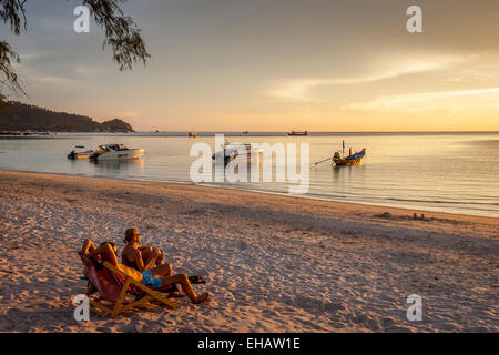 A Couple Watch The Sunset On Hat Sairee Beach, Ko Tao, Thailand Stock Photo