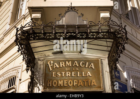 Argentina, Buenos Aires, San Telmo, Defensa, pharmacy sign on turn of century building Stock Photo