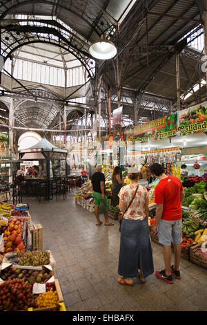 Argentina, Buenos Aires, San Telmo indoor produce market, shoppers at fruit and vegetable stall Stock Photo