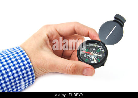 Caucasian man hand holding a black compass on white background Stock Photo