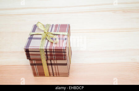 brown gift box with bow on wooden table Stock Photo