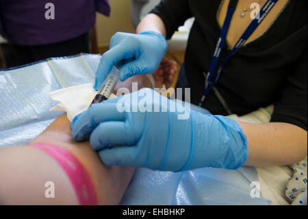A man has a blood test in a hospital Stock Photo