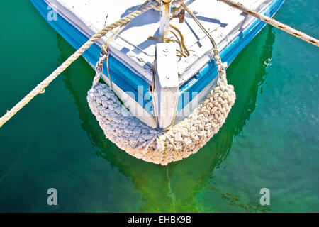 Old wooden boat prow in green water Stock Photo