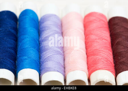 Row of colorful sewing threads Stock Photo