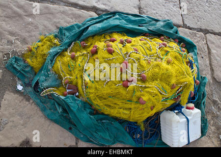 Yellow fishing nets, ropes and canister Stock Photo