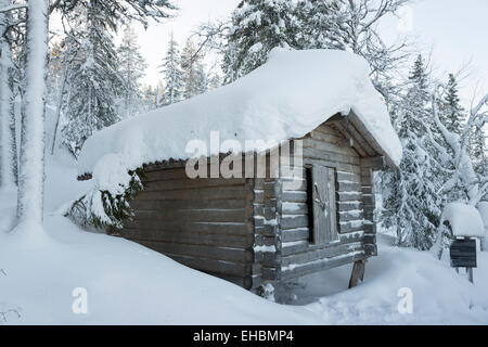 a traditional sami wooden store shed in snow in winter