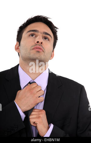 A businessman adjusting his tie. Stock Photo