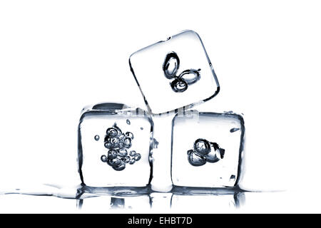 Three melting ice cubes with air bubbles inside on white background Stock Photo