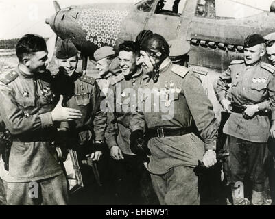 ALEXANDER POKRYSHKIN (1913-1985) Soviet ace pilot of WW2 is congratulated by colleagues after scoring another kill. Note stars indicating kills on his aircraft Stock Photo